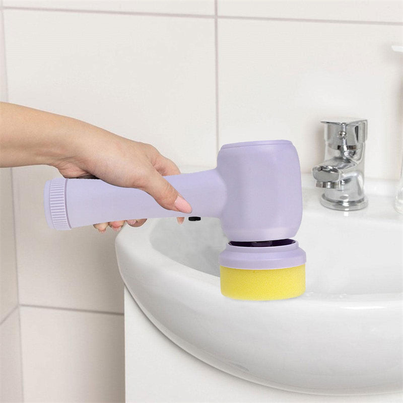 Handheld electric scrubber cleaning white ceramic bathroom sink